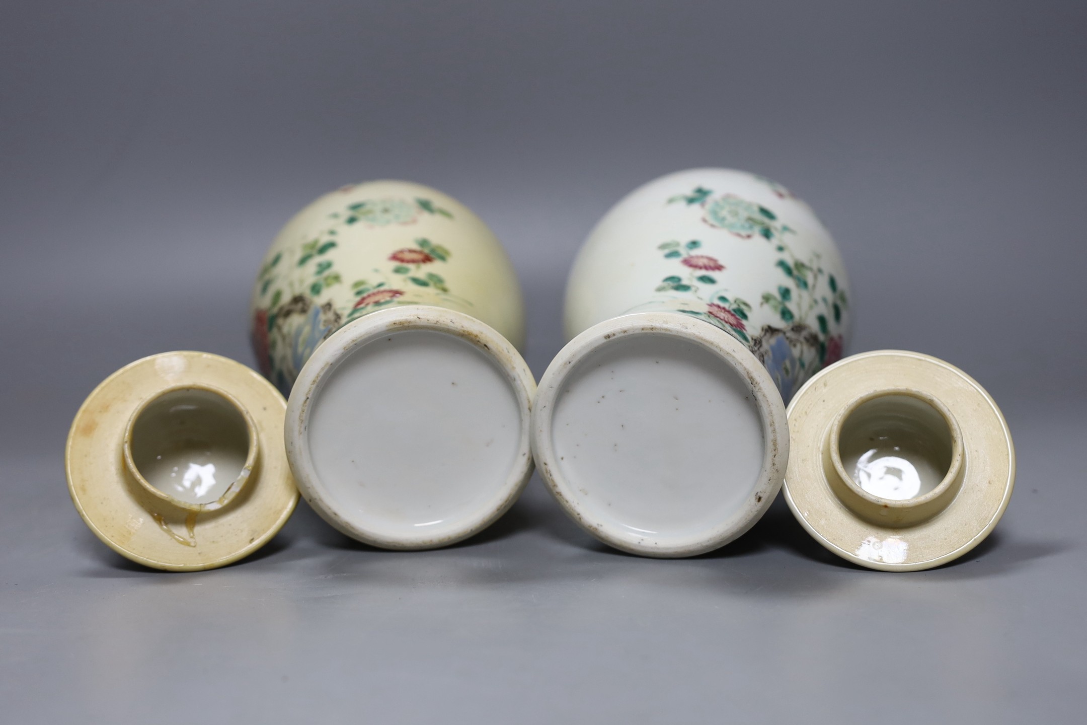 A pair of 19th century Chinese famille rose vases and covers - 27cm tall